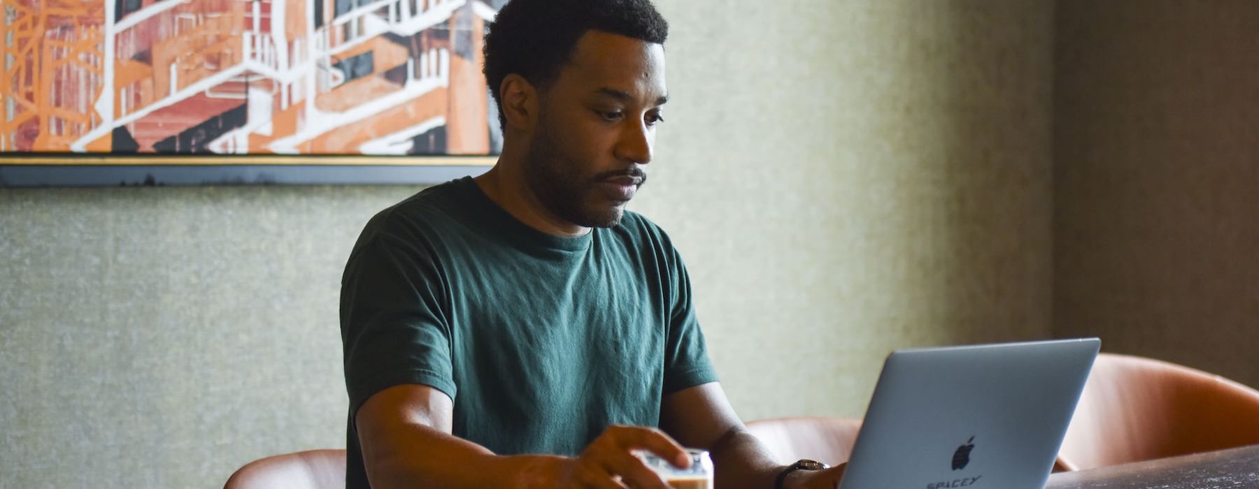 a man sitting at a table with a laptop