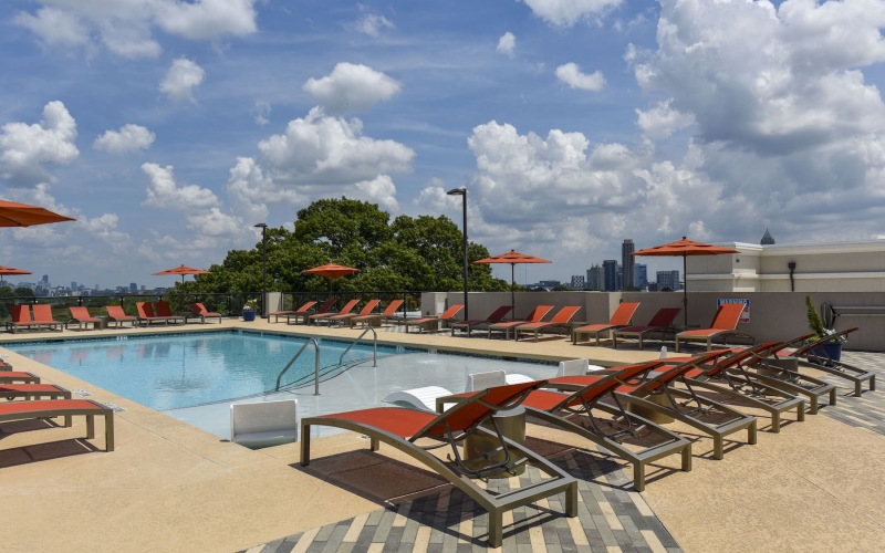 a swimming pool with chairs around it